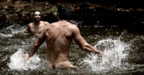 Two Guys Splashing in a River