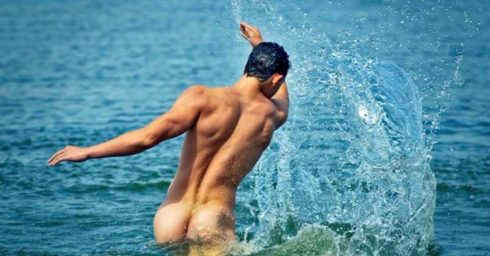 Rearview Naked Guy in the Ocean