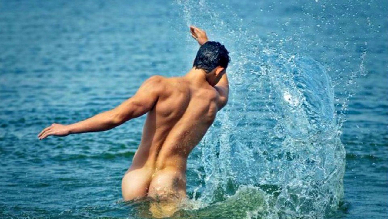 Rearview Naked Guy in the Ocean.