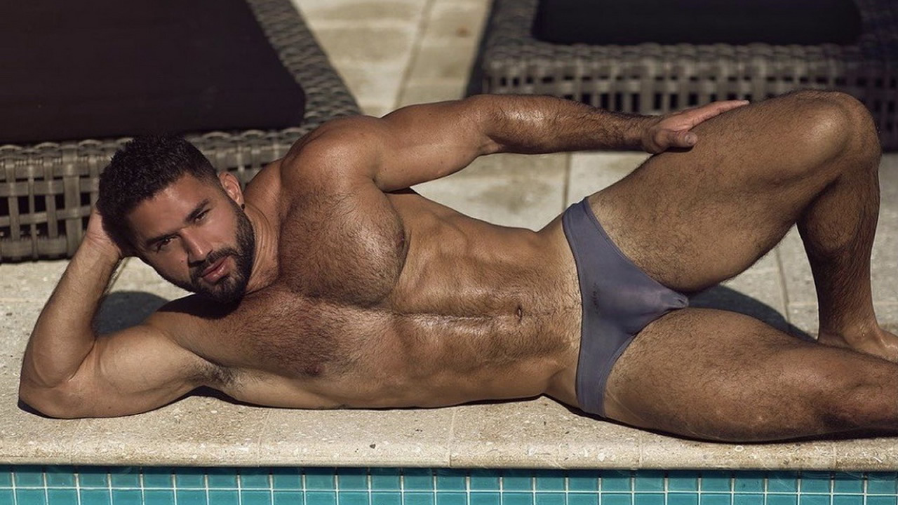 Muscular Hunk at the Edge of a Pool