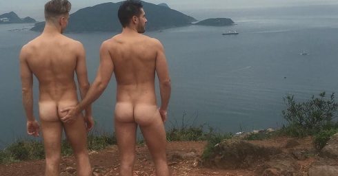 Rearview Two Naked Guys on a Hill Overlooking the Ocean