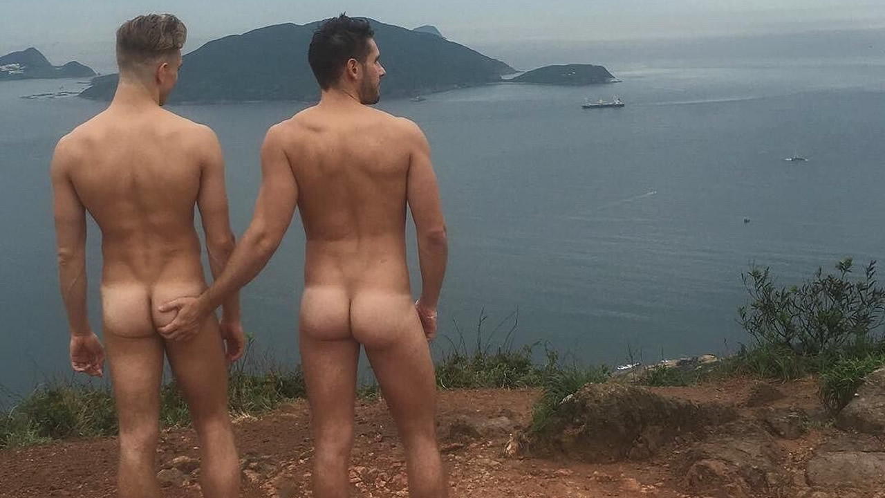 Rearview Two Naked Guys on a Hill Overlooking the Ocean