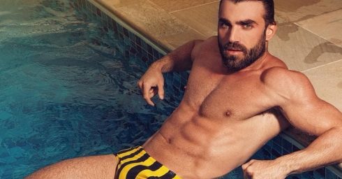 Fit Hunk in a Yellow and Black Striped Bikini in a Pool