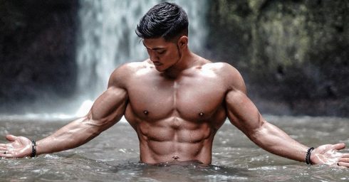 Muscular Stud in the Water by a Waterfall
