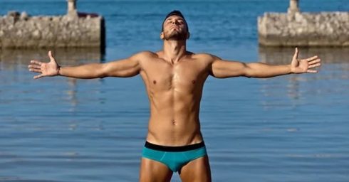 Fit Guy in a Blue Bikini by the Ocean