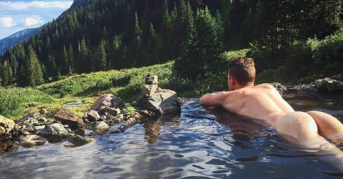 Rearview Naked Guy in a Mountain Stream