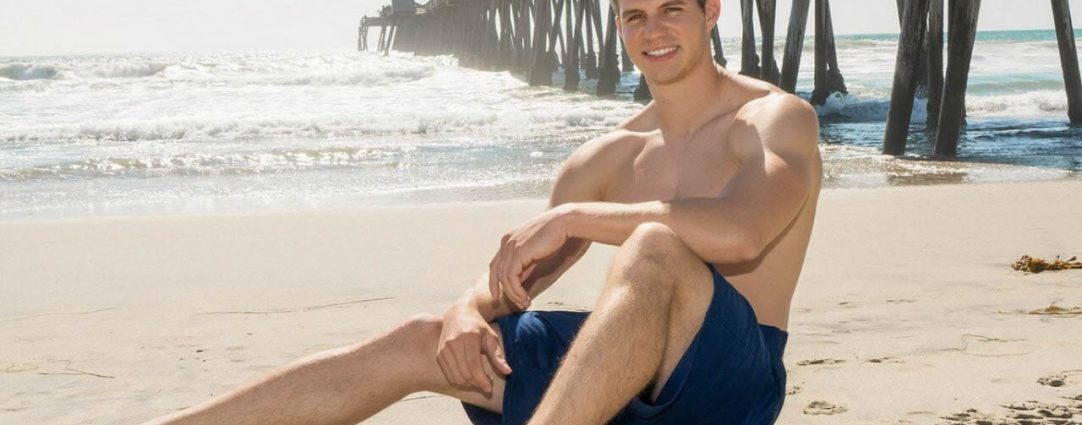Athletic Guy in Blue Shorts at the Beach