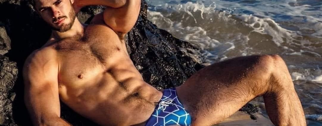 Fit Young Hunk in a Blue Bikini at the Beach