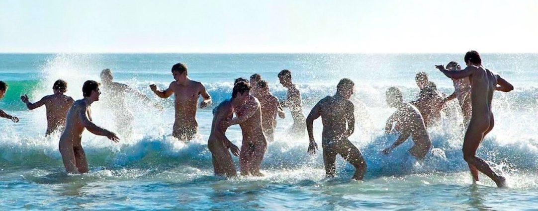 Young Guys Splashing at the Waters Edge