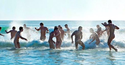 Young Guys Splashing at the Waters Edge