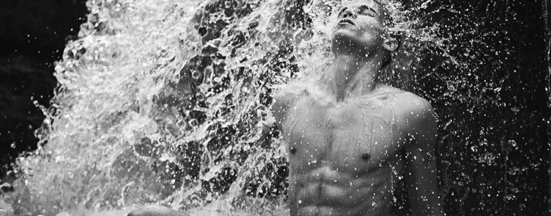 Black and White Ripped Guy in a Waterfall