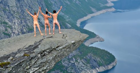 Rearview Three Naked Guys on a Rock Overhanging a Valley