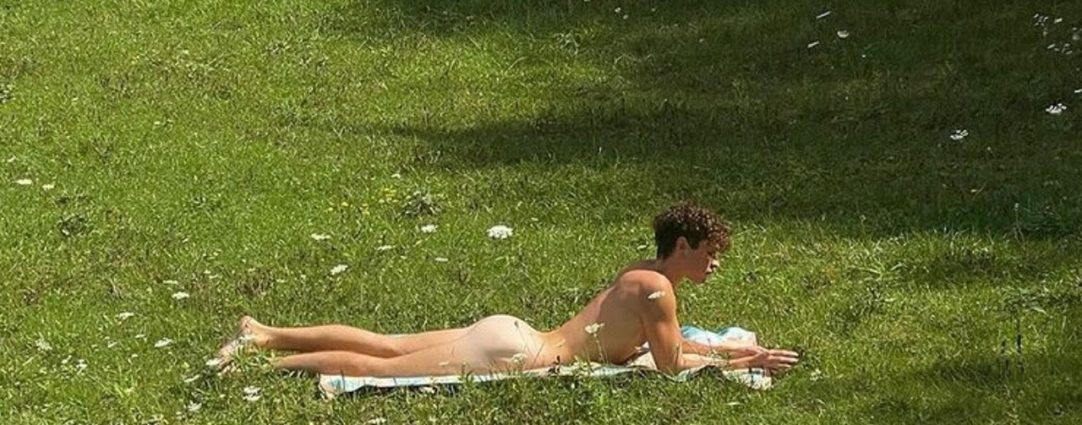 Rearview Naked Young Guy in a Grassy Field