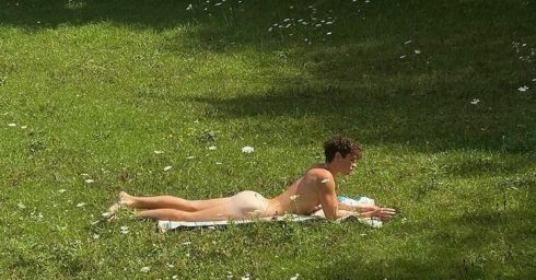 Rearview Naked Young Guy in a Grassy Field