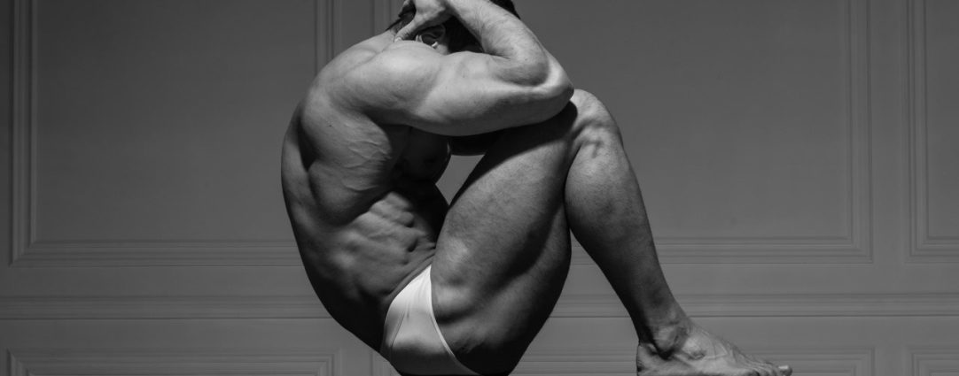 Black and White Muscular Stud on a Pedestal Table