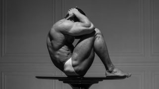 Black and White Muscular Stud on a Pedestal Table