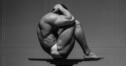 Black and White Muscular Stud on a Pedestal Table